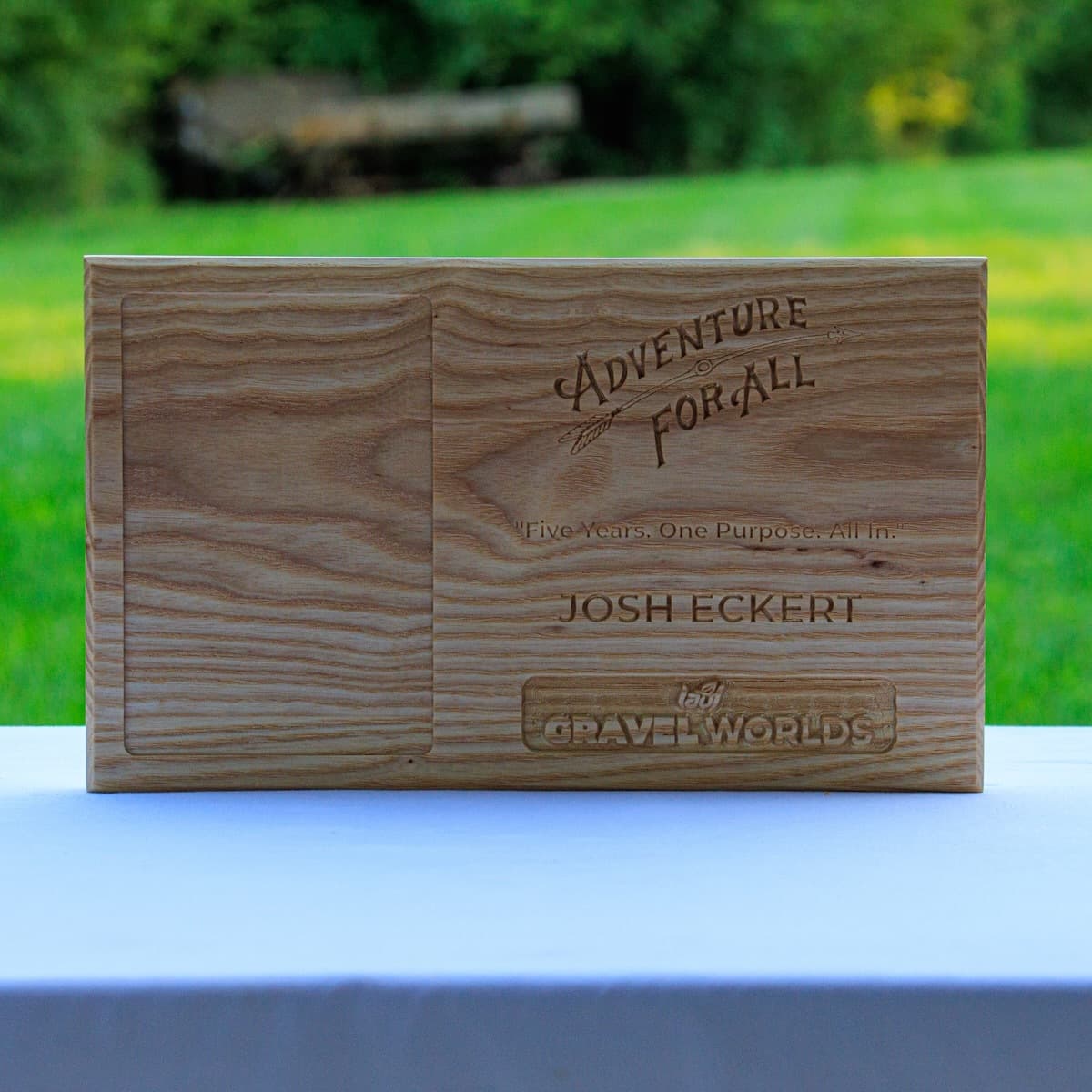 Ash wood trophy plaque for Josh Eckert displaying CNC-engraved Adventure for All branding with natural ash grain visible throughout the design.