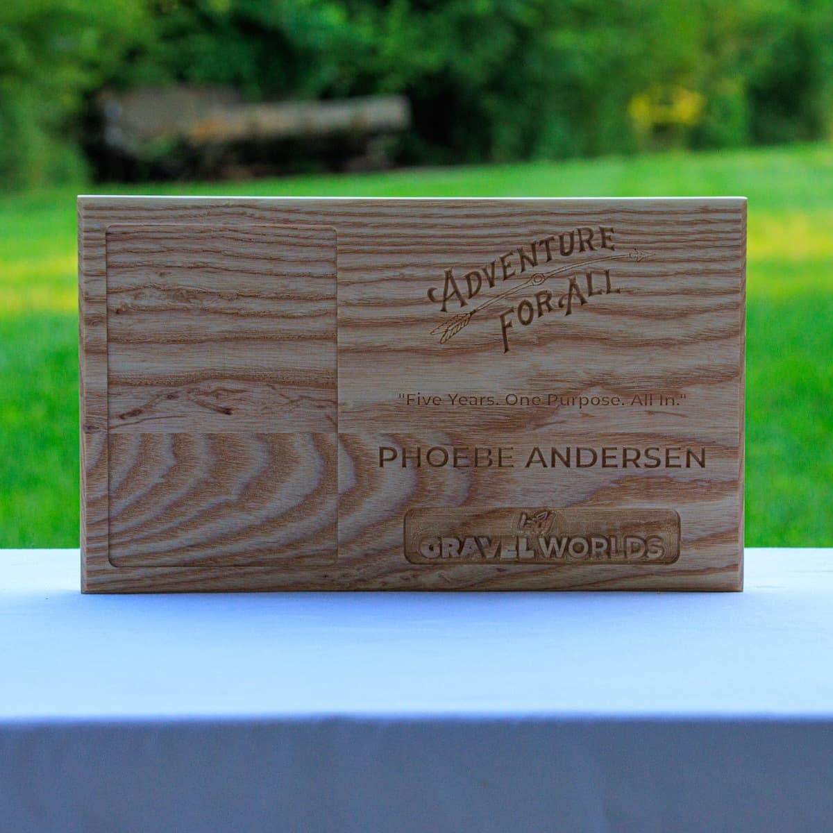 Trophy plaque for Phoebe Andersen featuring laser-engraved Adventure for All logo and Gravel Worlds branding on natural ash wood.