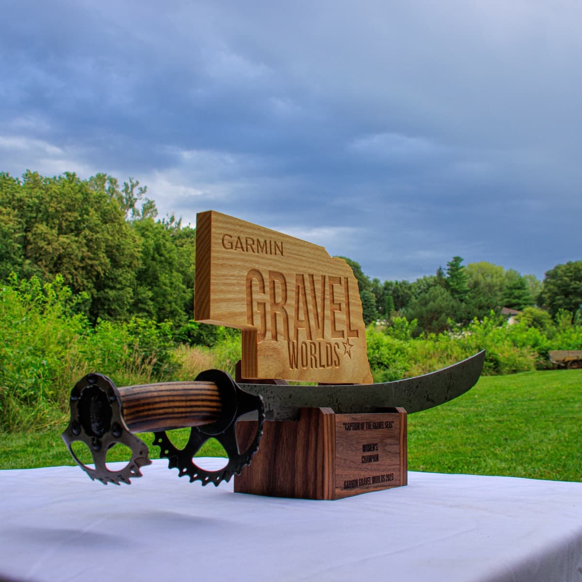 Individual Gravel Worlds sword holder trophy with Nebraska state outline on natural wood plaque engraved with Garmin branding and championship category text