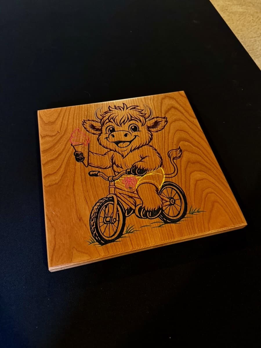 Single wooden ash trophy plaque with CNC-engraved cartoon mascot character riding a gravel bike