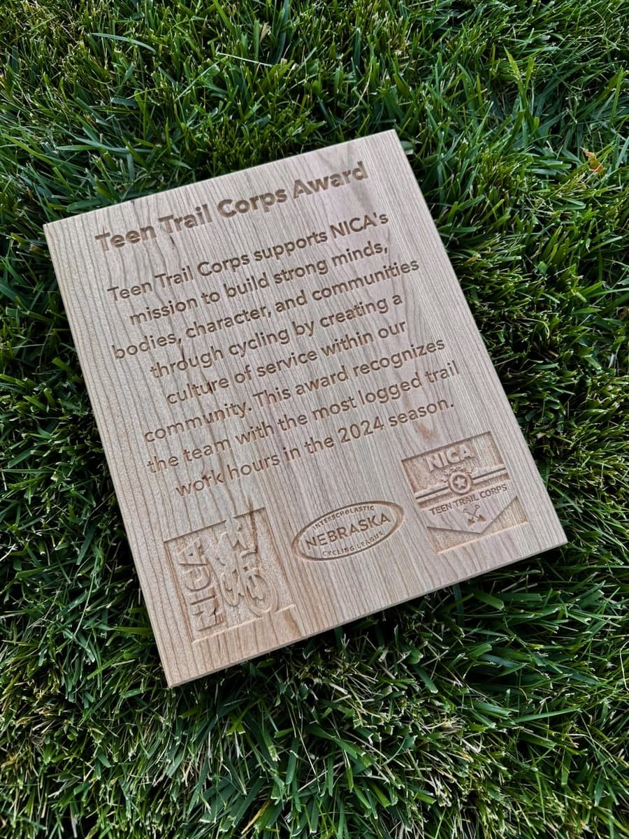 Cherry wood Teen Trail Corps Award plaque with CNC-engraved text celebrating service within NICA community and most logged trail work hours in 2024 season