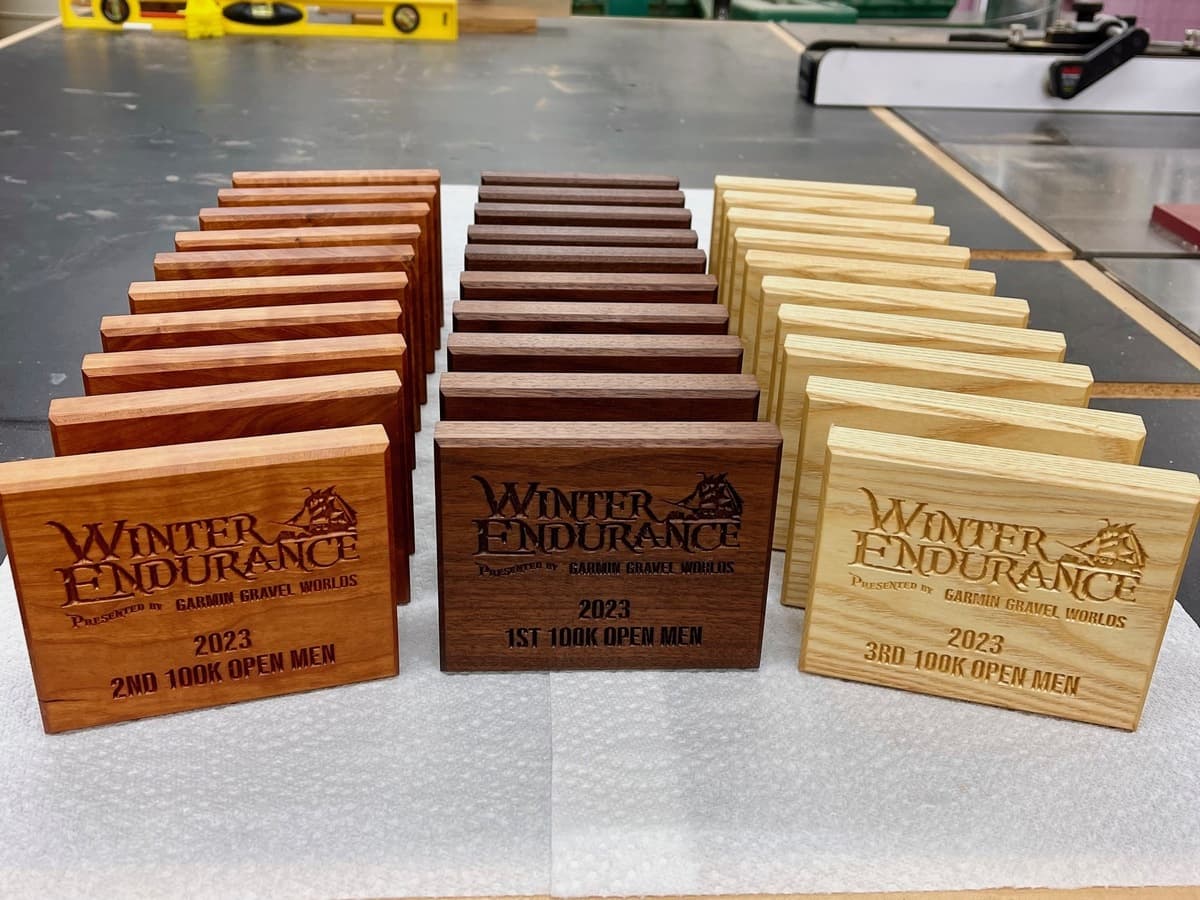 Individual Winter Endurance 2023 trophy plaque displayed against neutral background showing engraved text and wood grain detail