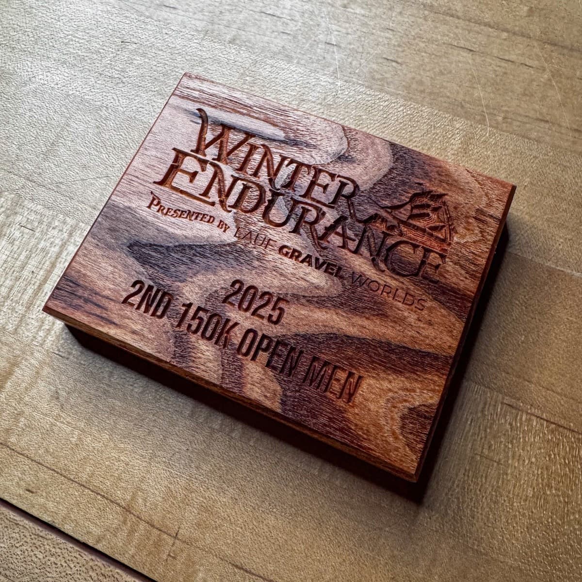 Red oak trophy plaque with engraved Winter Endurance branding for 2025 Second Place 150K Open Men's race category