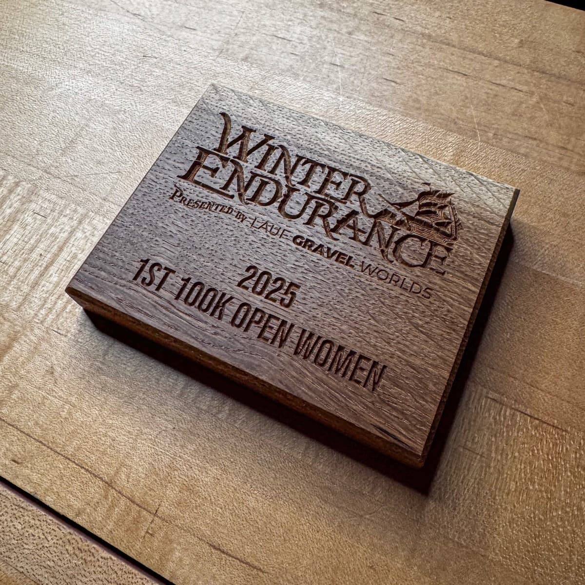 Winter Endurance wooden trophy plaque with CNC-engraved text and galloping horse graphic on natural light wood surface