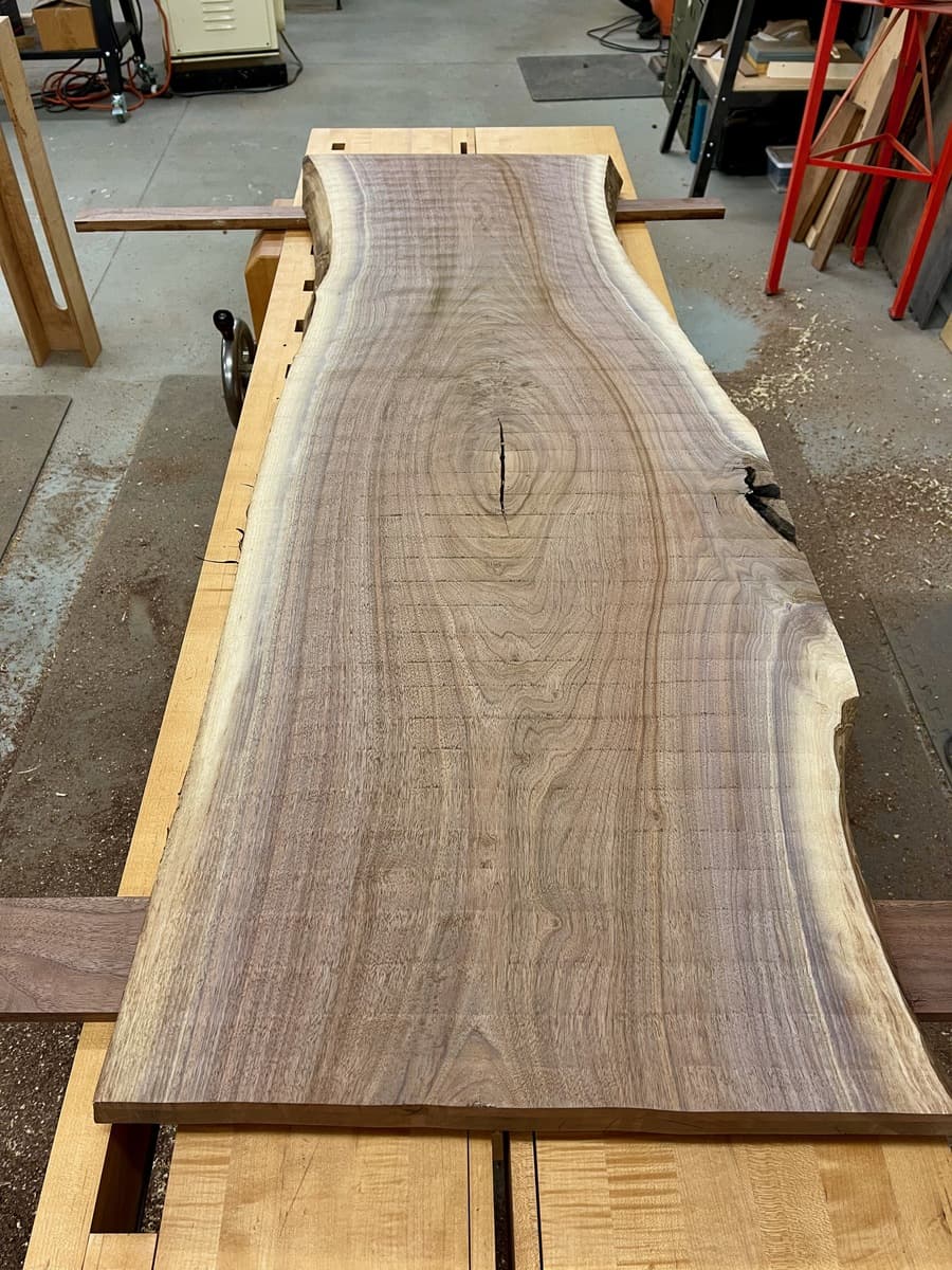 Waterfall table - live edge walnut slab in progress showing dramatic grain pattern during construction