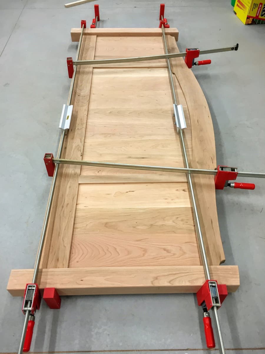 Footboard panels clamped together during assembly with rails visible