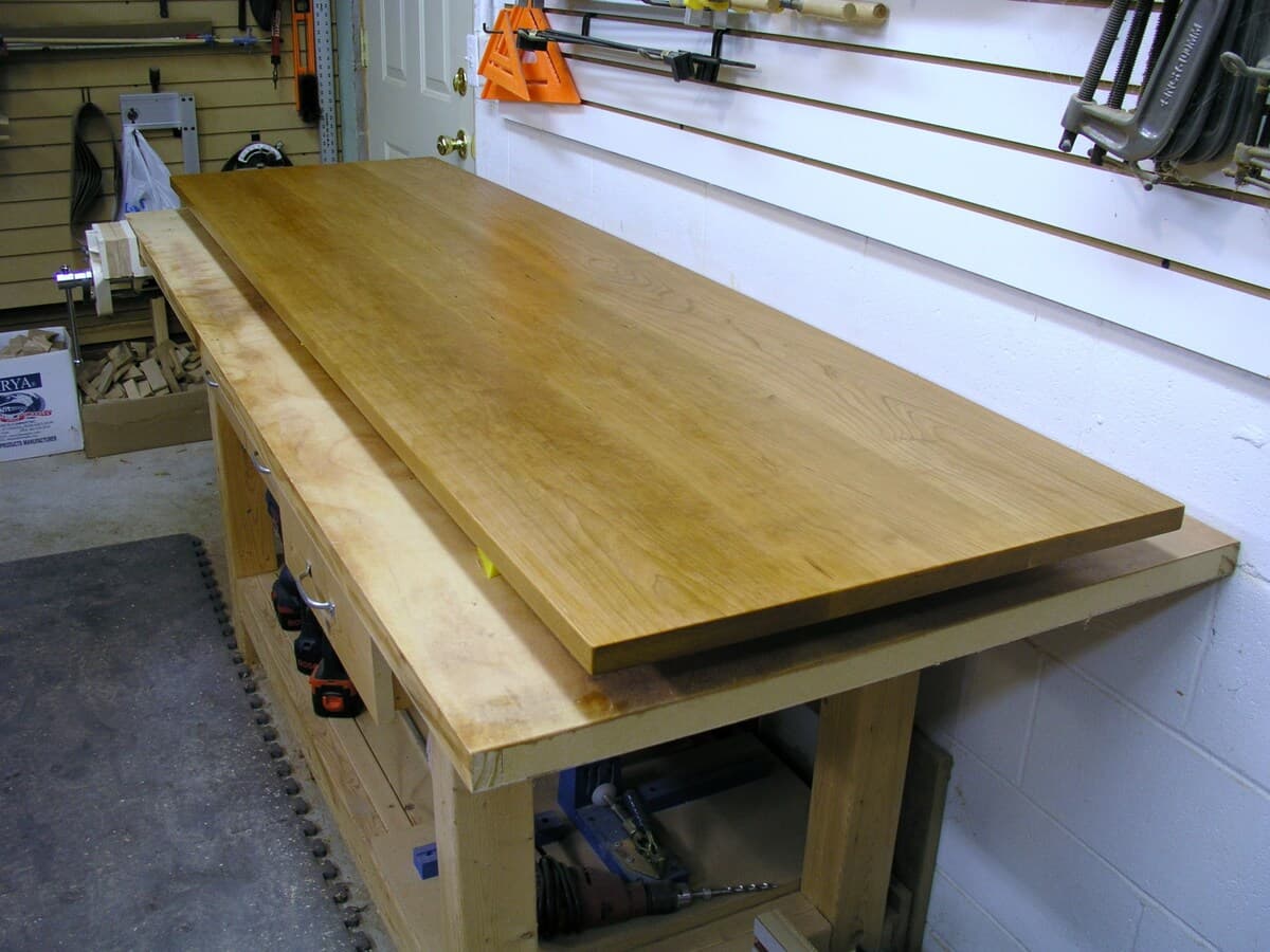 Cherry wood top panel in the workshop showing grain pattern and finishing preparation