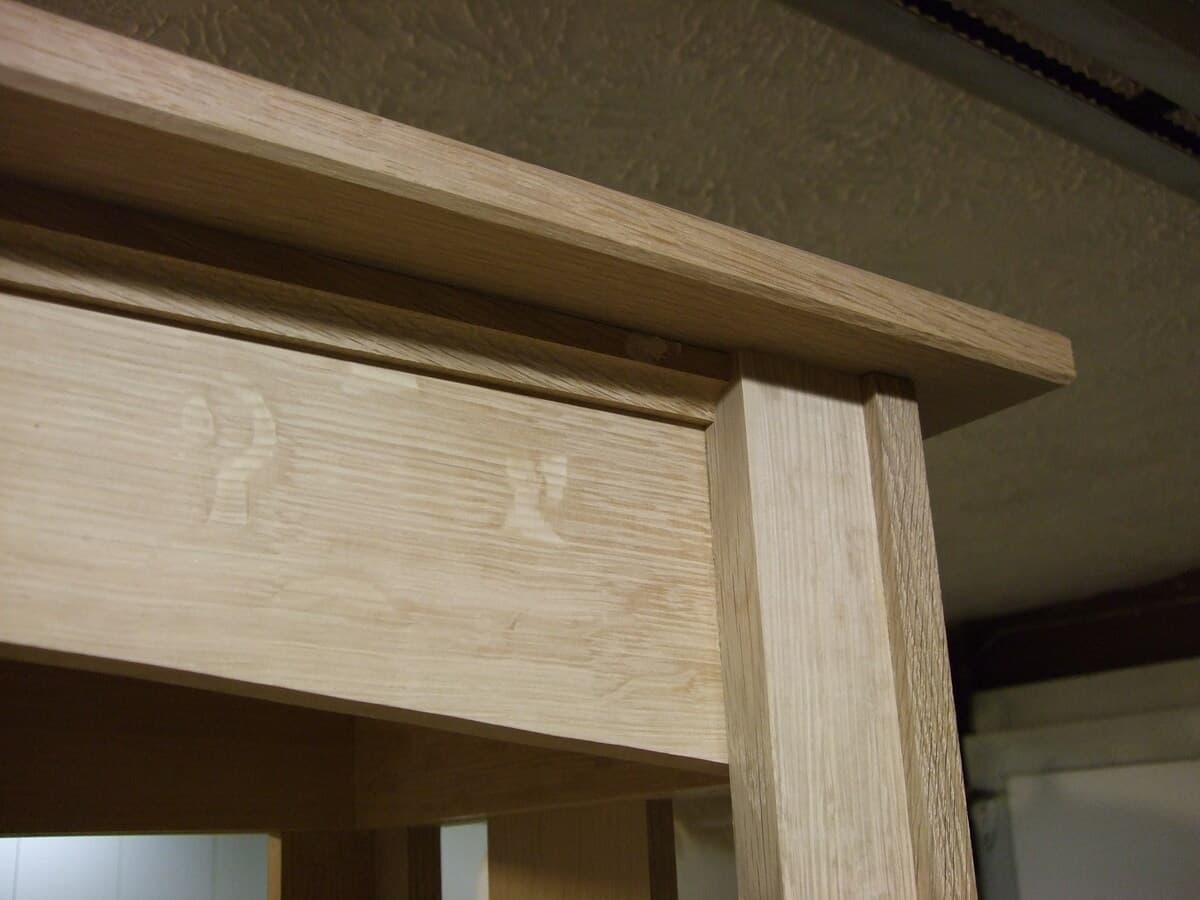 Detail of Mission bookcase mortise and tenon joinery corner connection, highlighting precise craftsmanship in quarter-sawn white oak with visible medullary rays