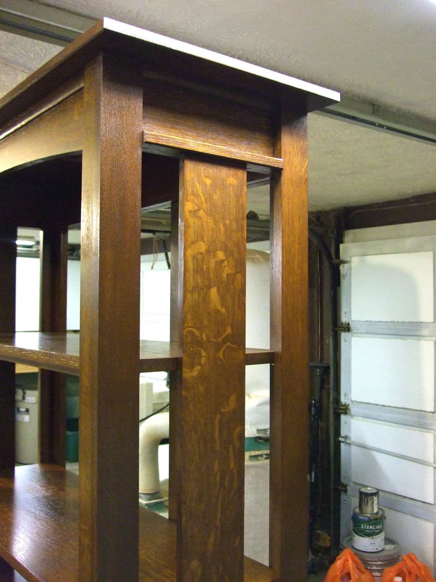 Completed mission bookcase in workshop setting with rich Shellac and Waterlox Satin finish, showcasing the bookcase as a finished piece with five horizontal shelves