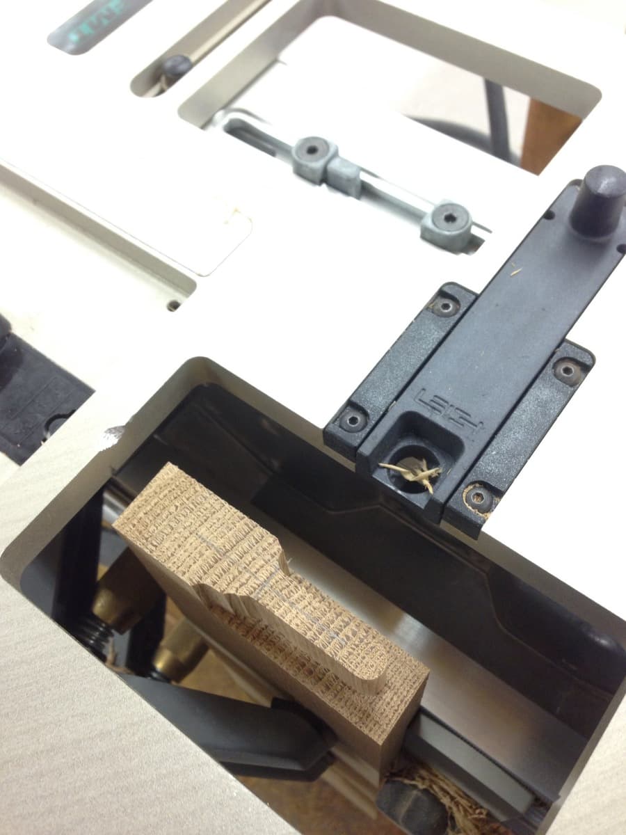 Mission style table hardware detail showing mortise and tenon joinery components laid out for assembly