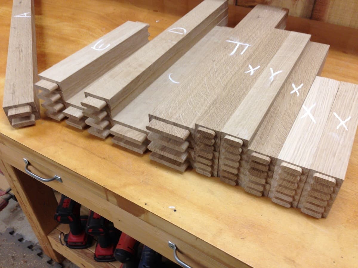 Quarter-sawn white oak components showing grain pattern with pencil markings for assembly sequence