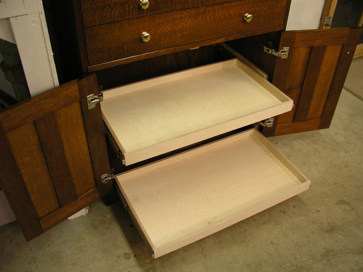 Detail shot showing multiple drawers extended from the tool cabinet, revealing the hand-cut dovetail joinery and light wood interiors, demonstrating the precision craftsmanship and quality construction of the rift and quarter-sawn red oak piece.