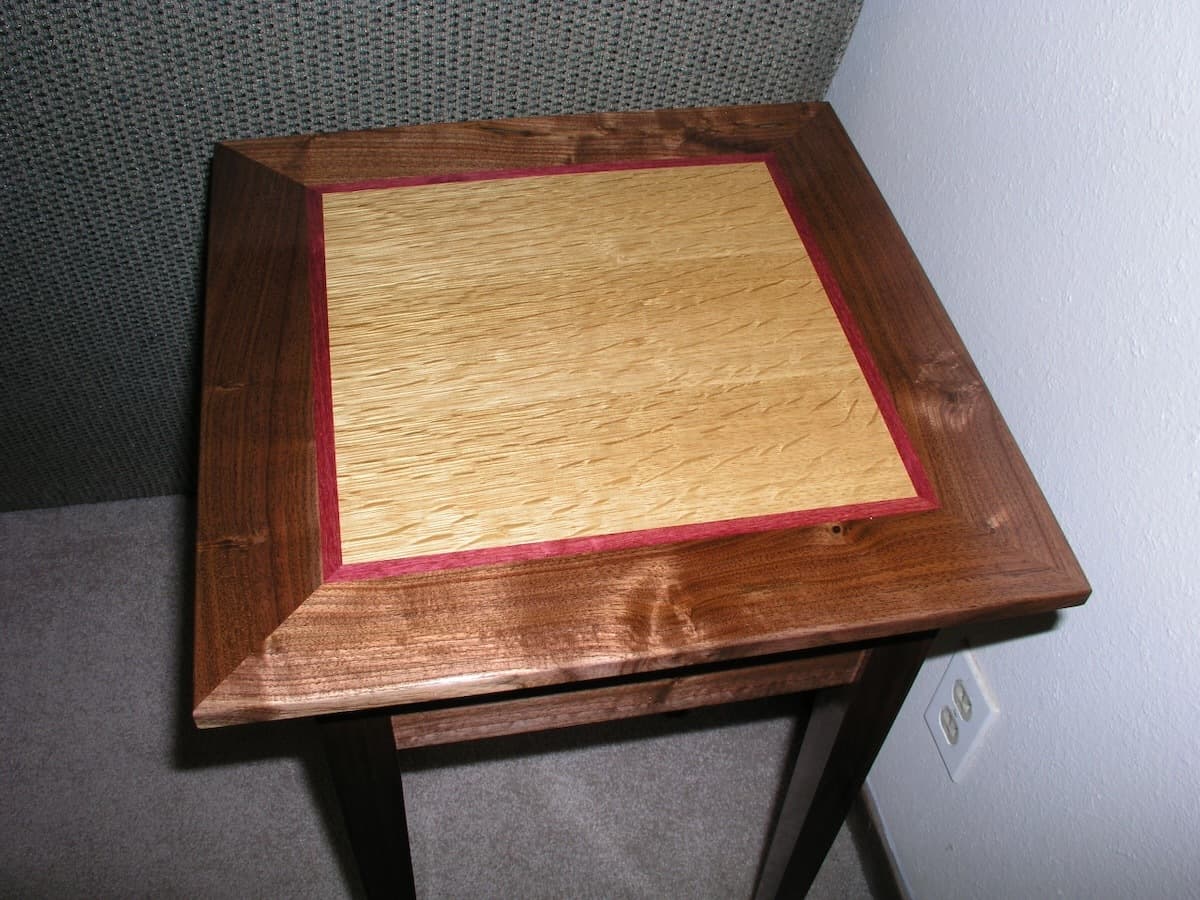 Top-down view showcasing three-wood design with white oak center and purpleheart accent