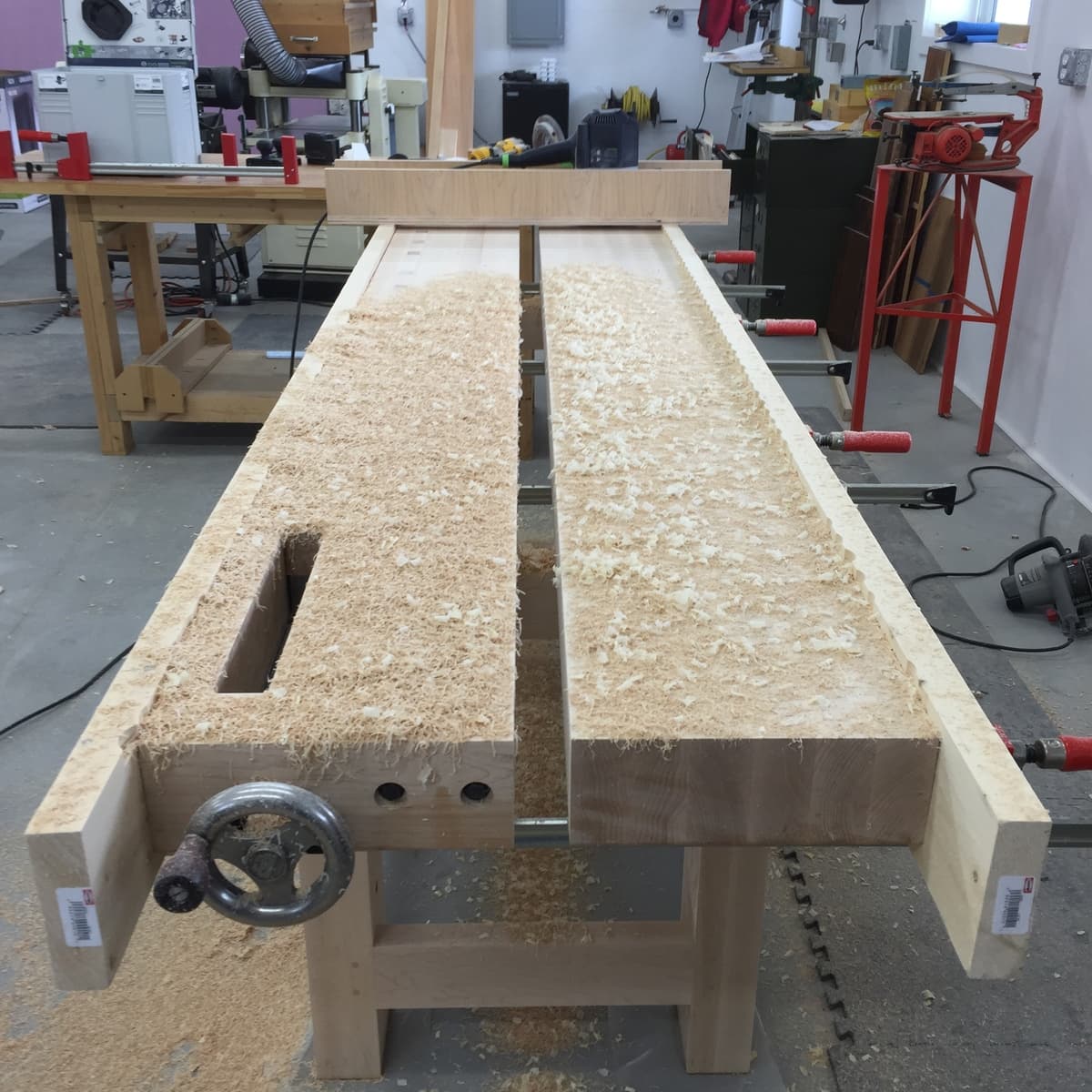 End view of workbench showing unfinished hard maple with beautiful grain figure and edge-glued top construction